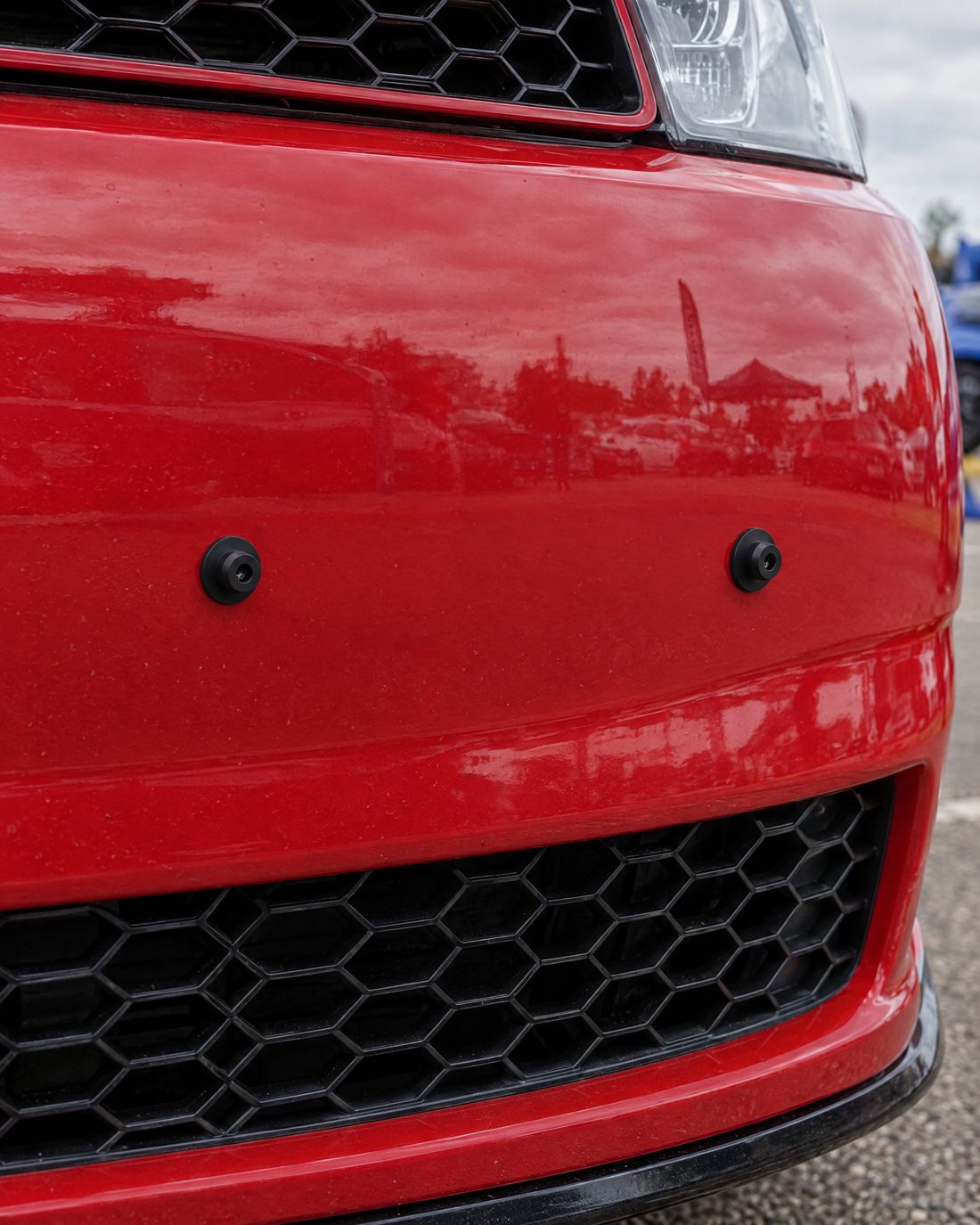 Close-up of the two small round Regless pegs on a red bumper
